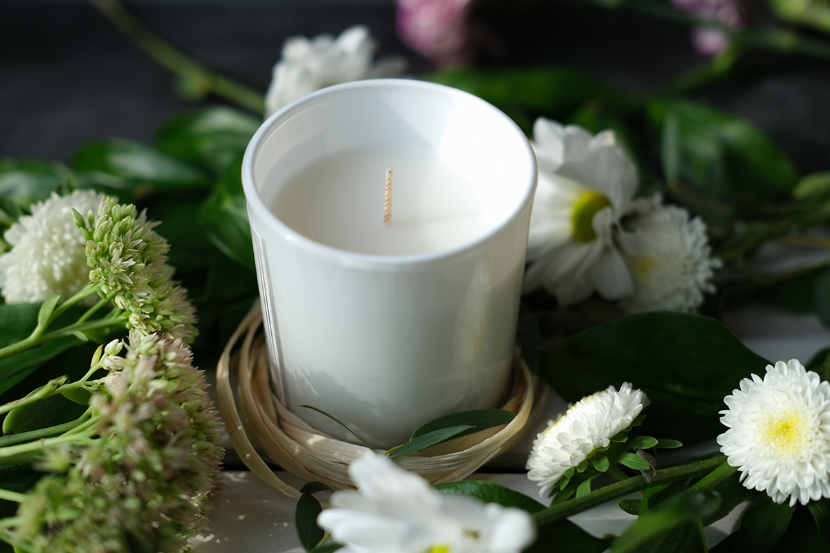 Candle Surrounded by Flowers Symbolizing the Impact of Therapy in Las Vegas